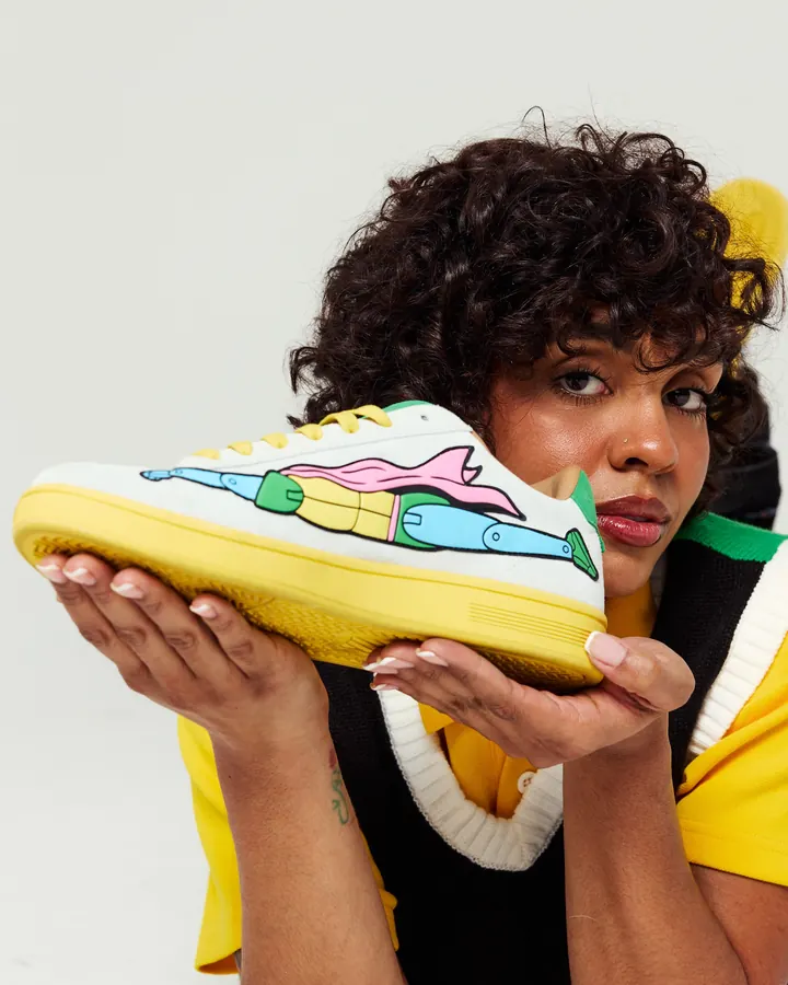 K-Swiss × Action Figure Miles campaign: a model holds the shoe to the camera