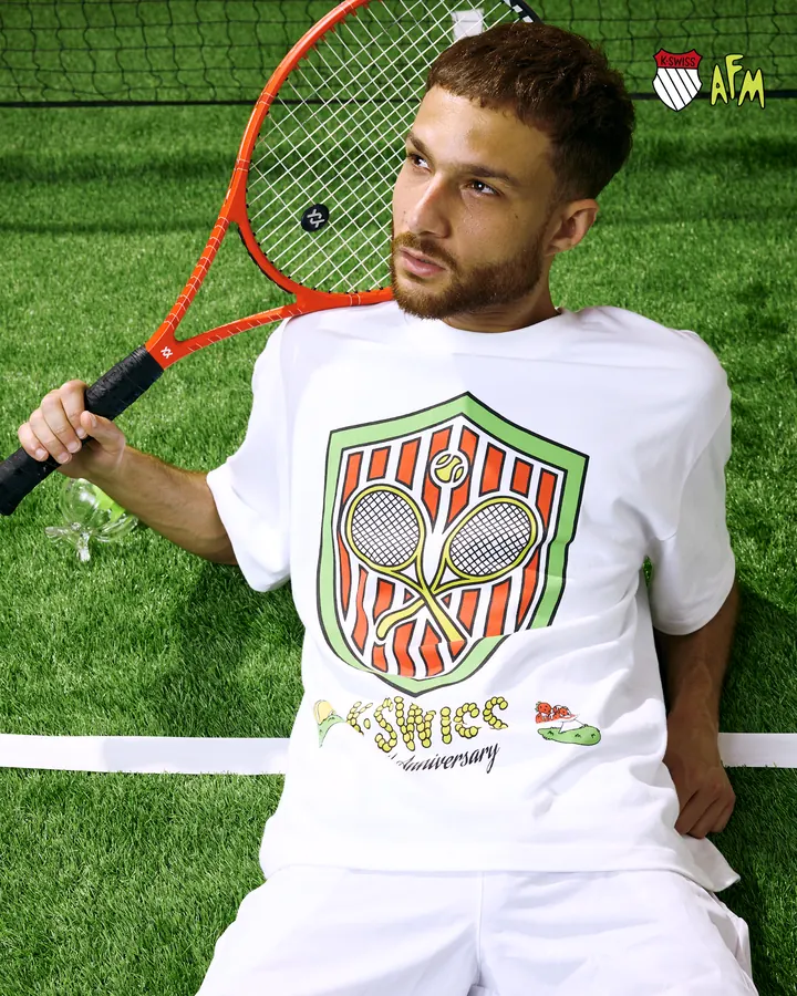 K-Swiss × Action Figure Miles tennis: a player with a racket on a grass court