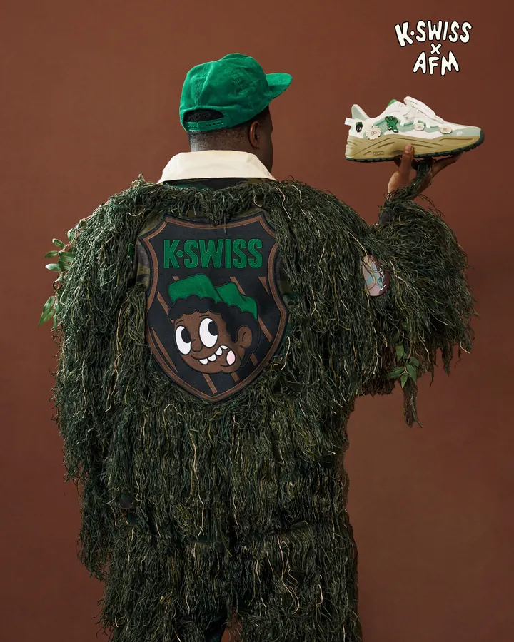 K-Swiss × Action Figure Miles: a figure in a ghillie suit with a K-Swiss patch holds the shoe